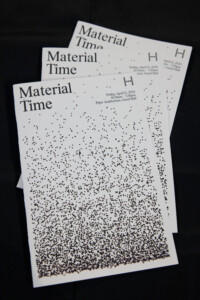 Three copies of a printed black-and-white pamphlet with the title "Material Time". The cover image features black dots arranged with greater density at the bottom and gradually decreasing density toward the top of the page.