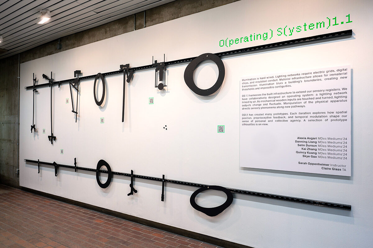 A white wall displaying a variety of black silhouetted shapes.