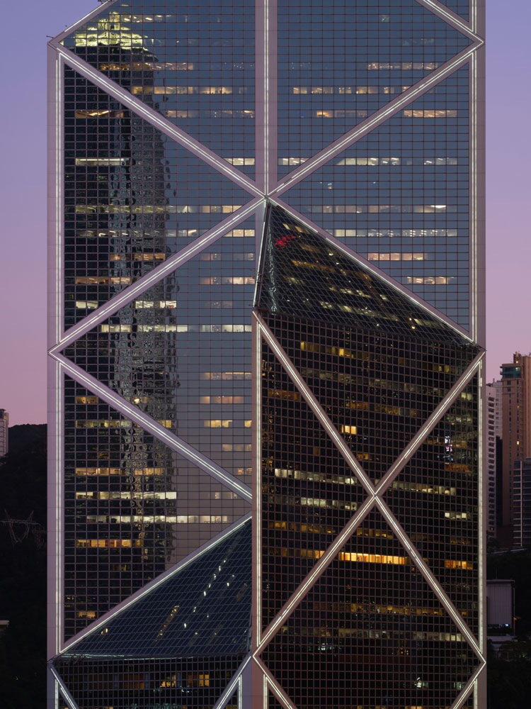 A photograph of the Bank of China Tower in Hong Kong at dusk.