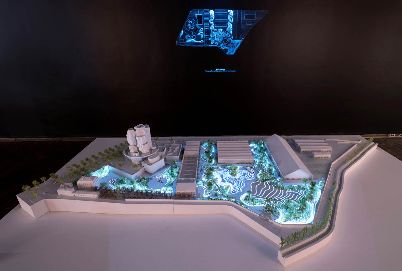 A model witha. projected diagram lighting it up.