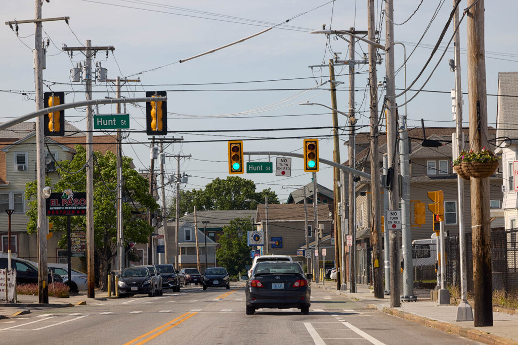 Photos of a street scene with a car going through a green light