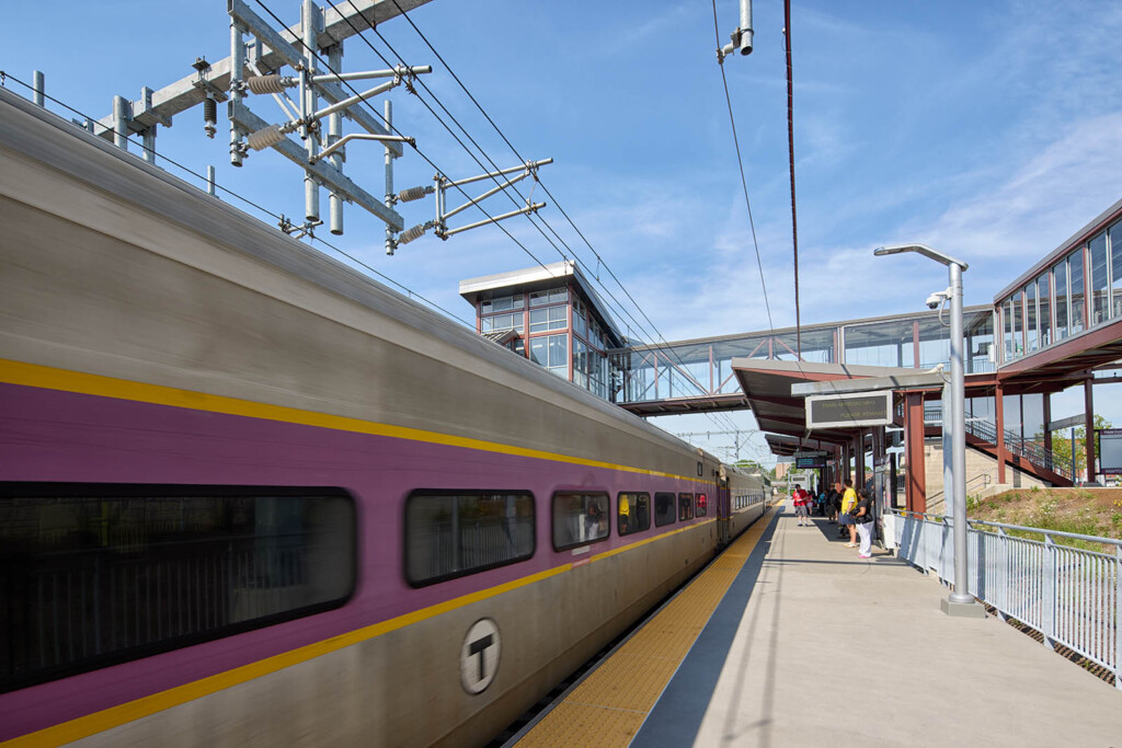 Train platform with an approaching train and people getting ready to board the train