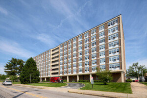 Photo of an apartment building with a red fire rescue track in front of it.