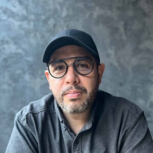 Headshot of Miguel Robles-Duran against a gray backdrop.