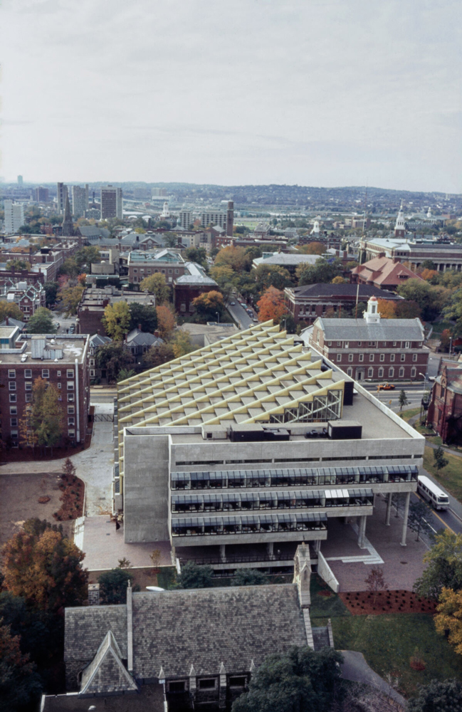 Aerial view of concrete building near brick buildings