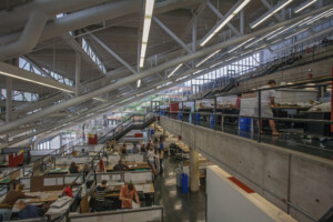 View of students at desks inside open, multilevel studio space