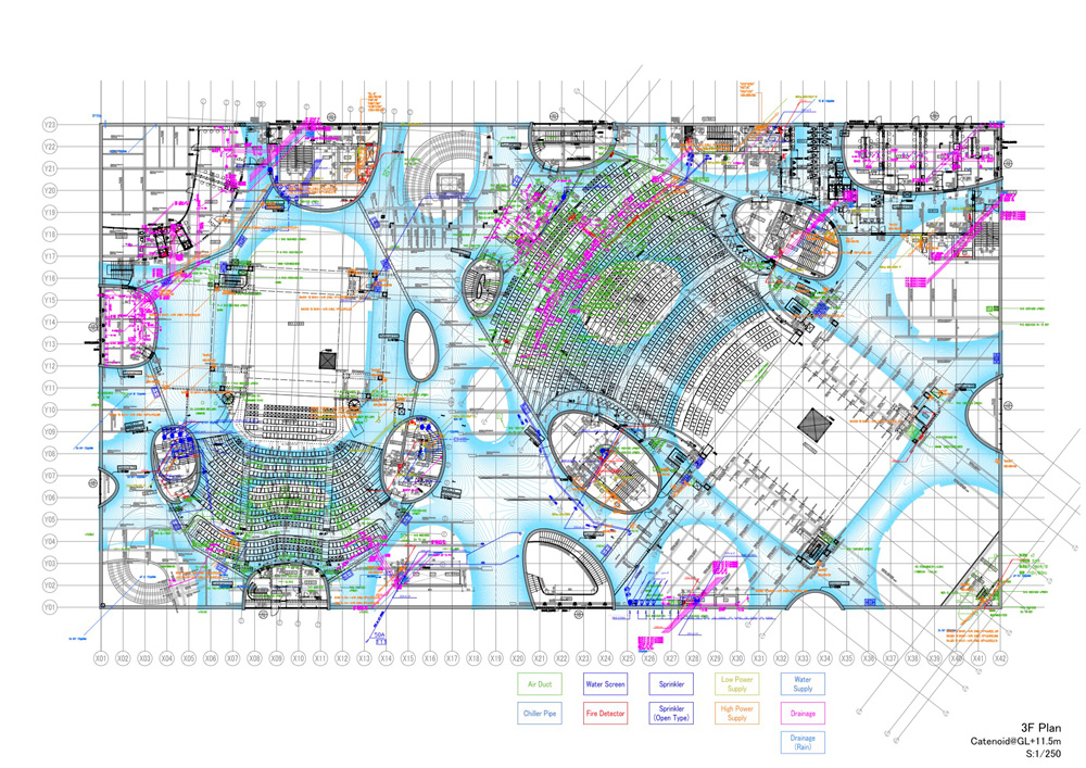 An architectural drawing showing the plan for a theater with lines and markings in many colors indicating various building systems.