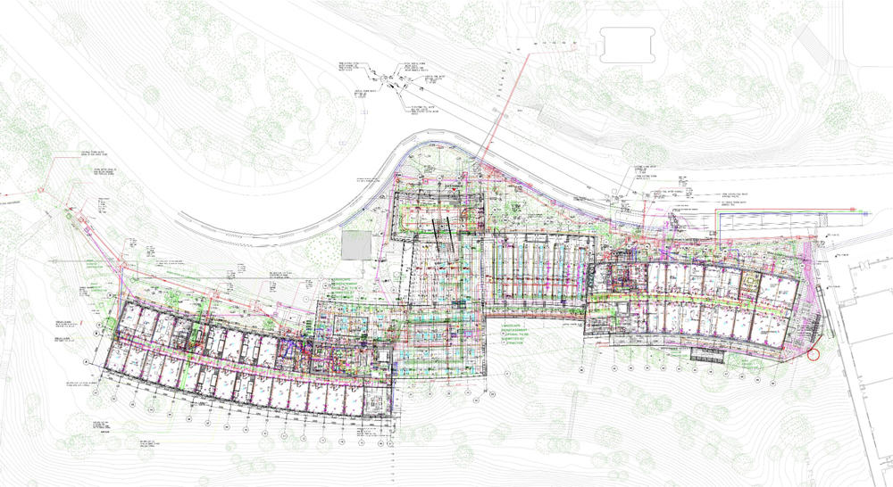 An architectural drawing showing the plan for a dormitory building with lines and markings in many colors indicating various building systems.