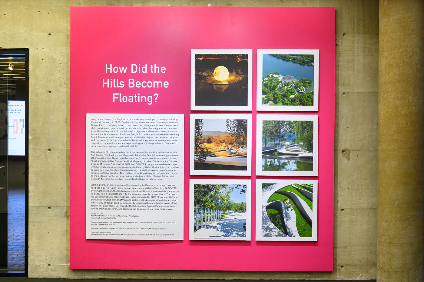 Hot-pink introductory wall, with title, text panel, and six photographs of urban landscapes