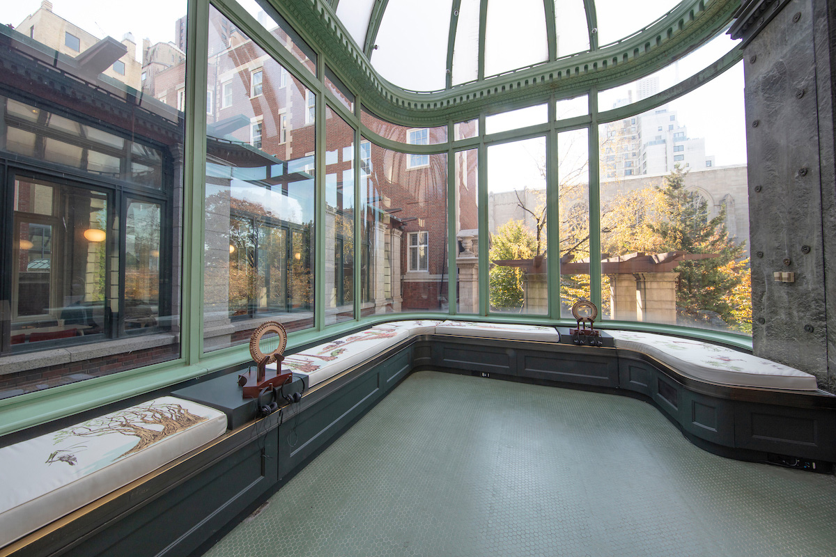 In a glass-walled conservatory, a view of Installation of “Ebb + Flow” by Artists in Residence in Everglades in "Making Home—Smithsonian Design Triennial" at Cooper Hewitt, Smithsonian Design Museum.