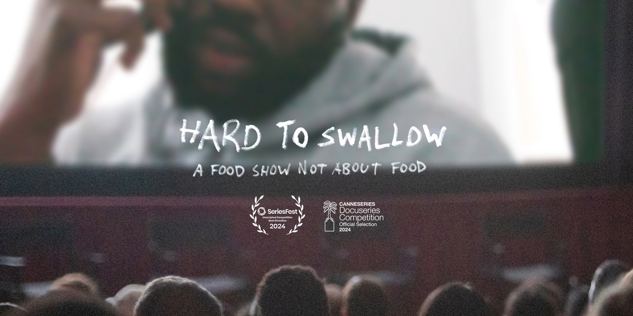 A cinema full of people staring at the screen with Hard to Swallow playing.