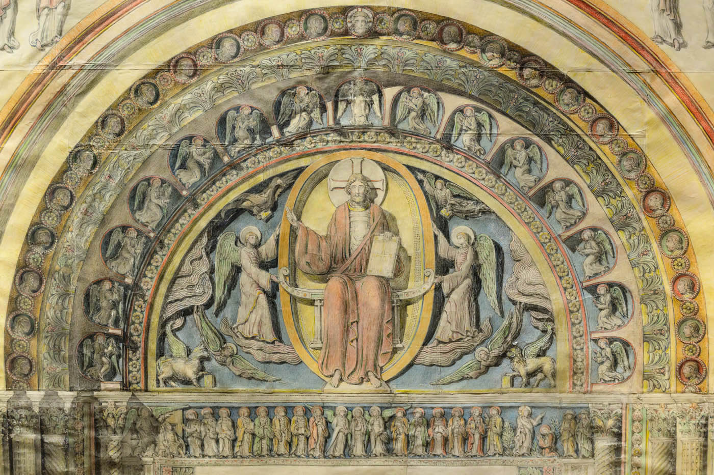 A detail of painting of a sculpture, in the arch above a church door.