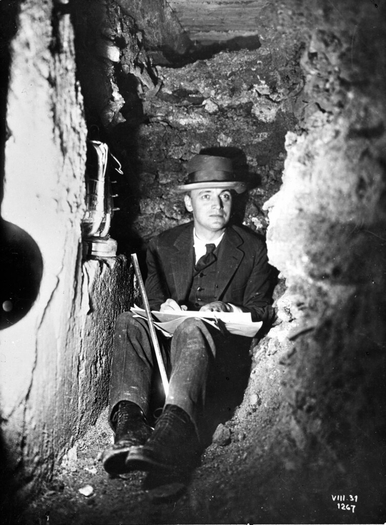 Old photo of a man sketching in a trench