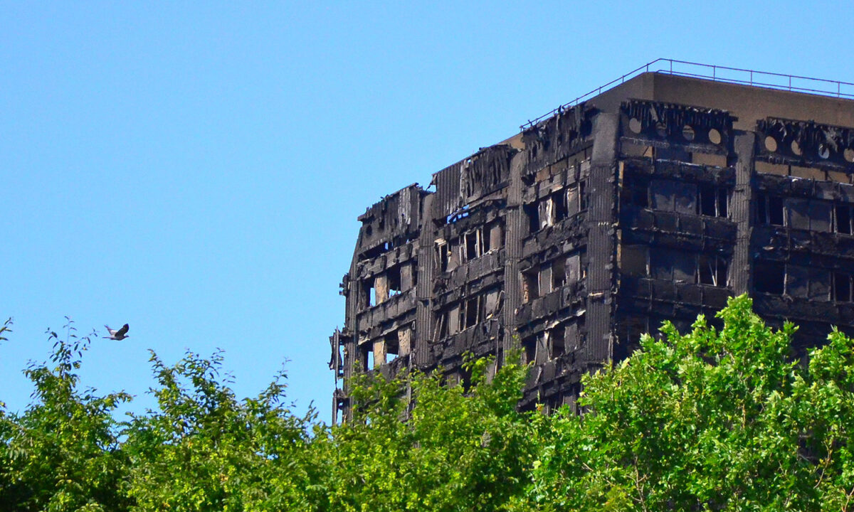 A photograph of the charred ruins of Grenfell Tower in London.