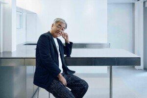Portrait of Kengo Kuma seated with elbow rested on a table