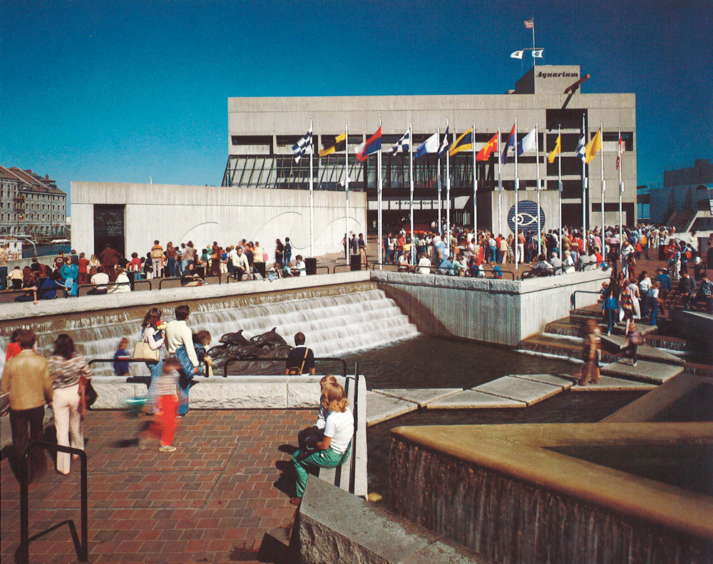 Concrete building with plaza and fountain