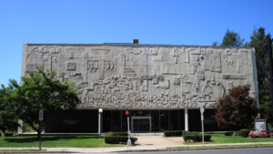 Building with concrete sculptural panels across the front