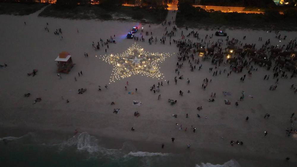 star shape in light on beach at night