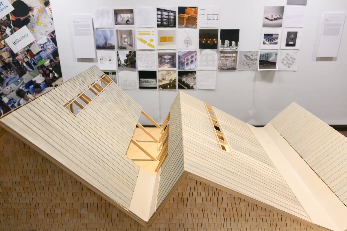 Detail of a wooden architectural model showing a roof with multiple angles.