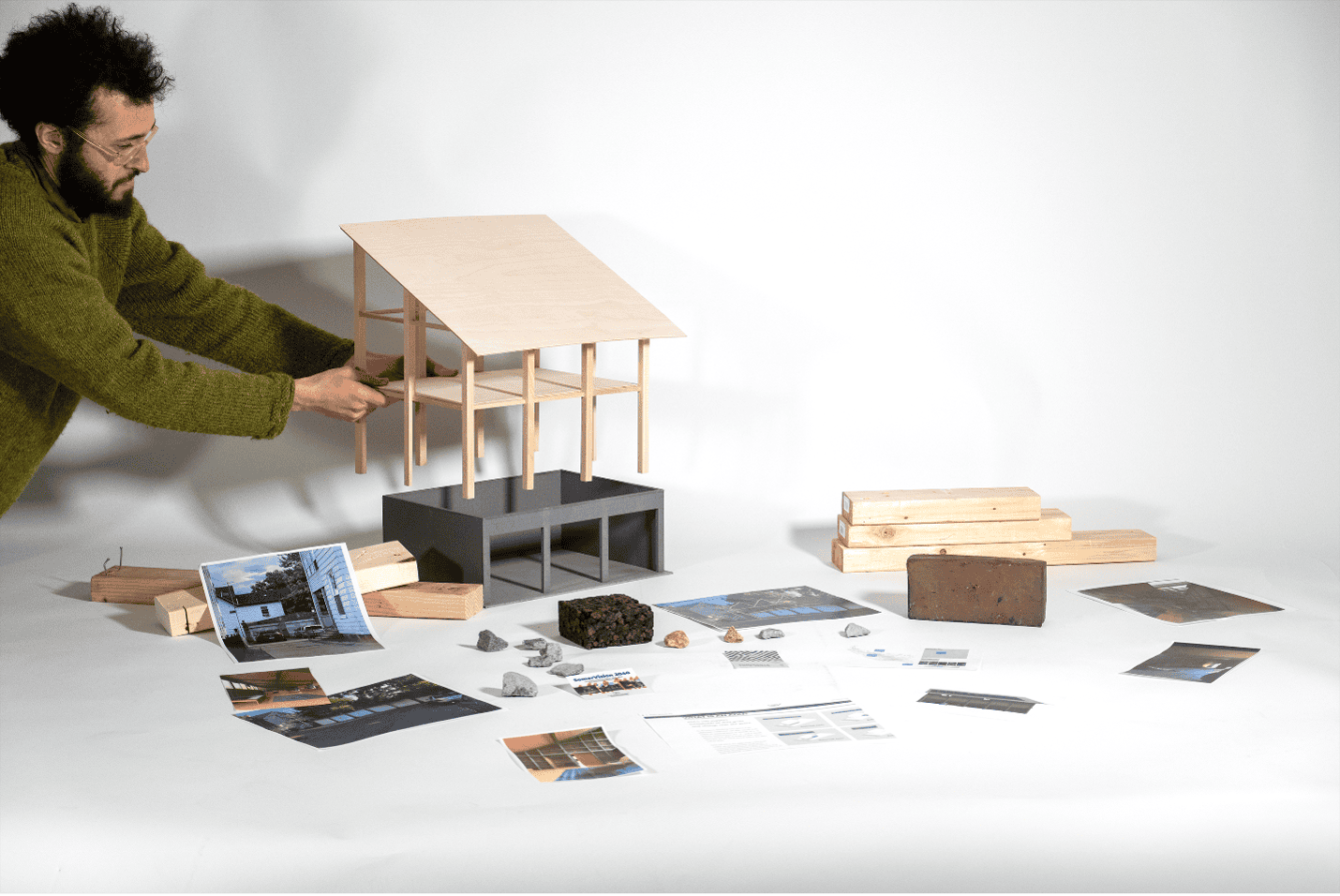 Person putting together a model of a building