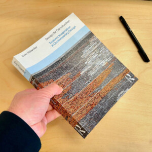 hand holding book on desk
