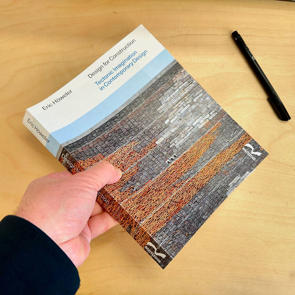 hand holding book on desk