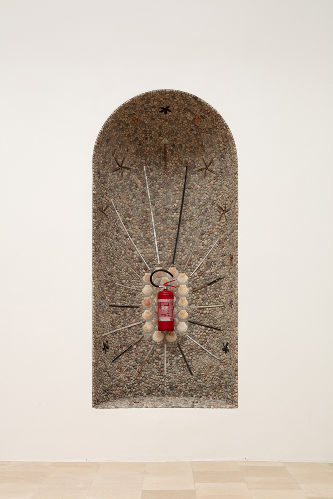 fire extinguisher in stone encrusted niche