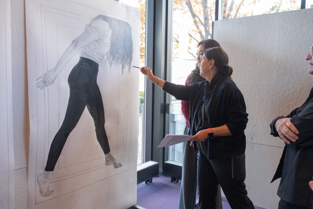 Ewa Harabasz instructs a student in front of drawing