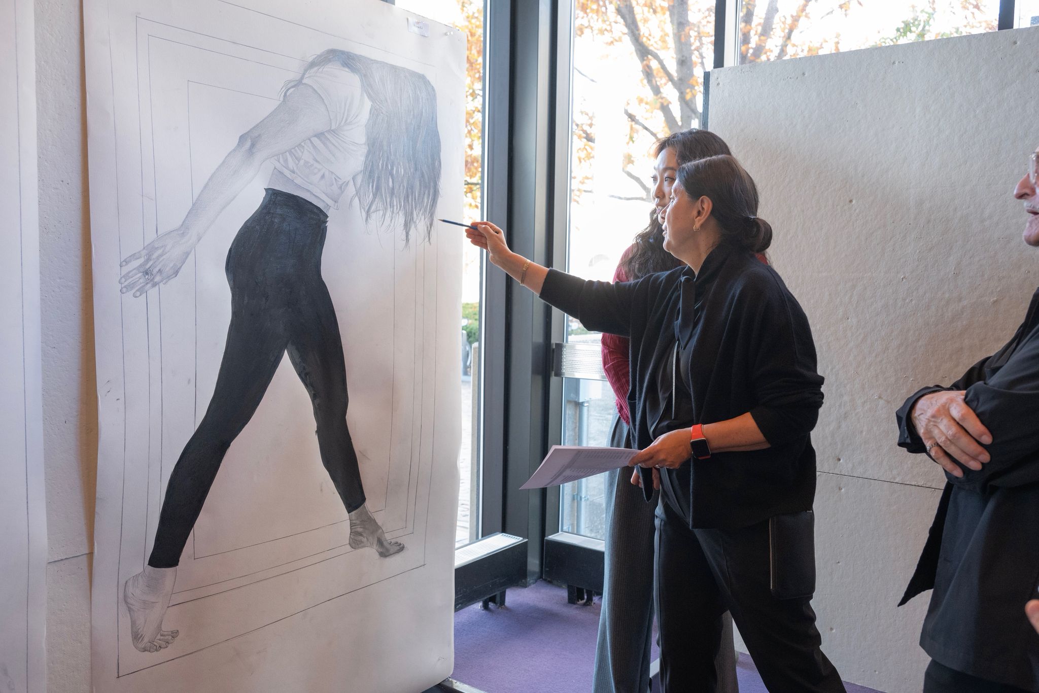 Ewa Harabasz instructs a student in front of drawing