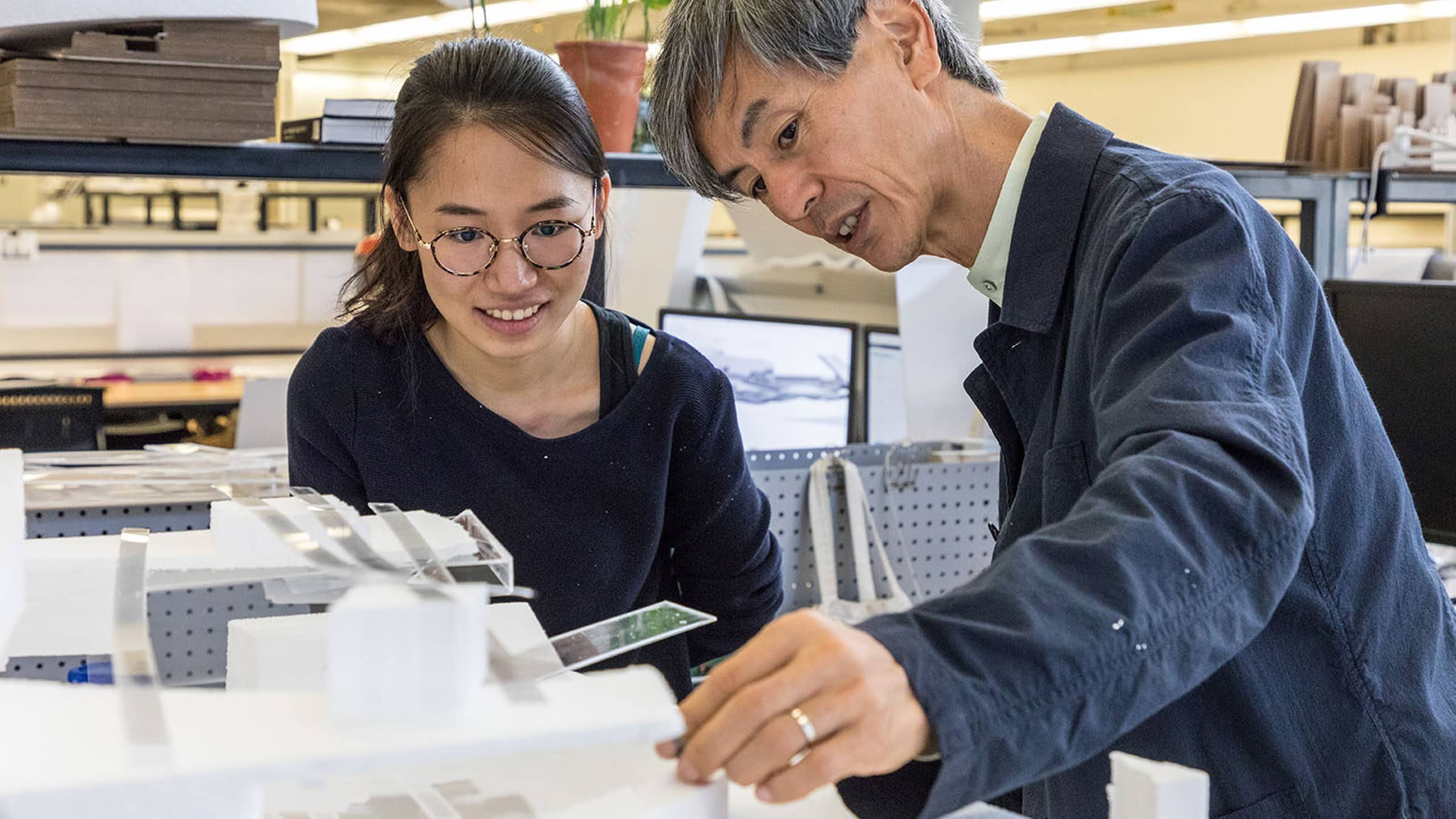 Student and professor discussing student work.