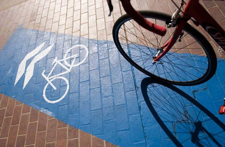 View of painted bike lane on a walkway with a bike in the foreground.