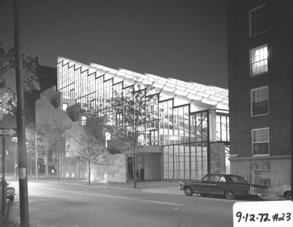 Black and white exterior view of Gund Hall south facade at night.