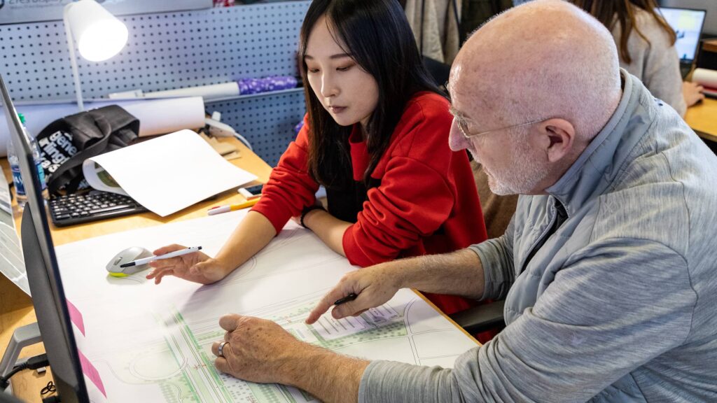 Professor and student discussing student work.