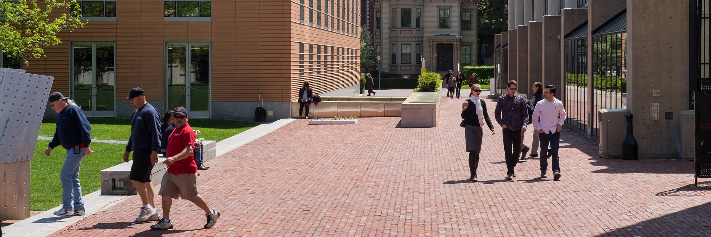 Exterior view of campus with people walking along the sidewalks.