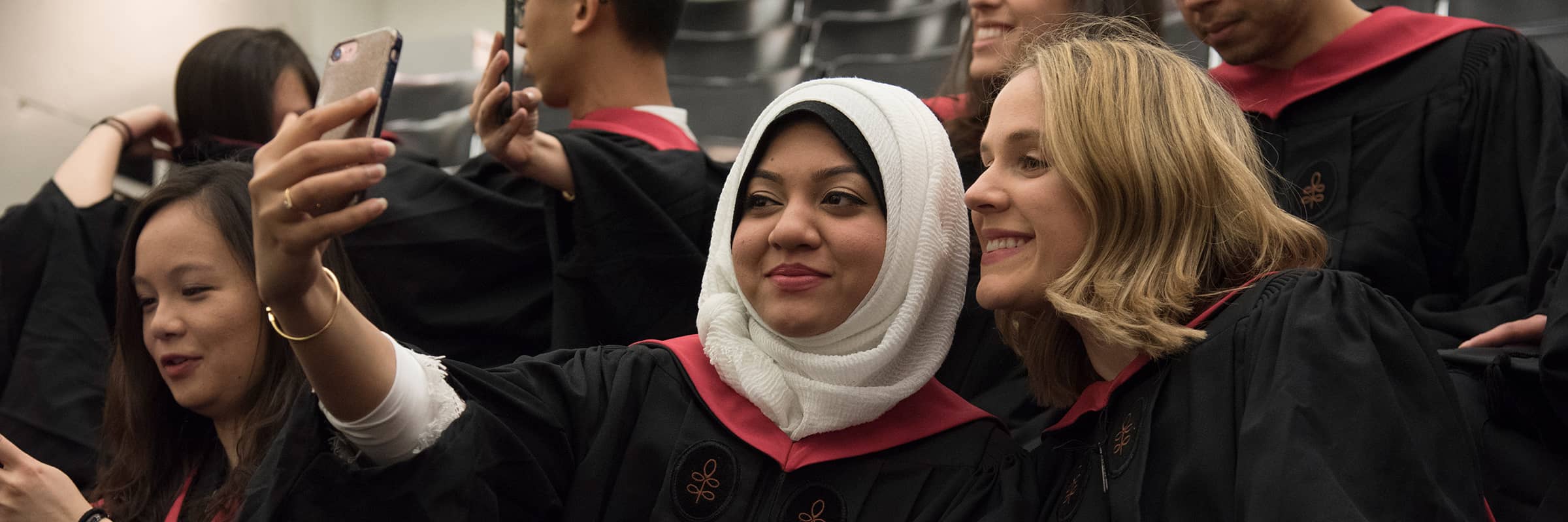 Group of graduates taking a selfie.