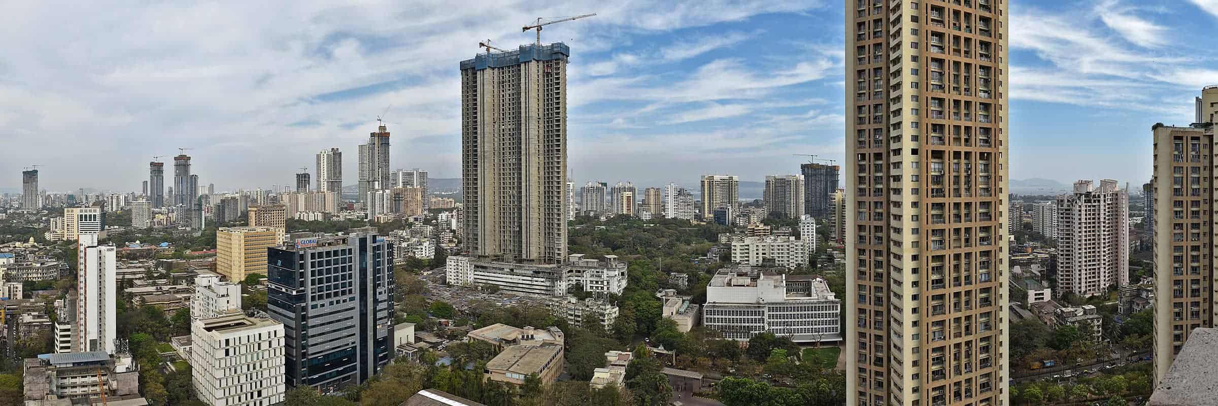 Cityscape with several tall buildings under construction.
