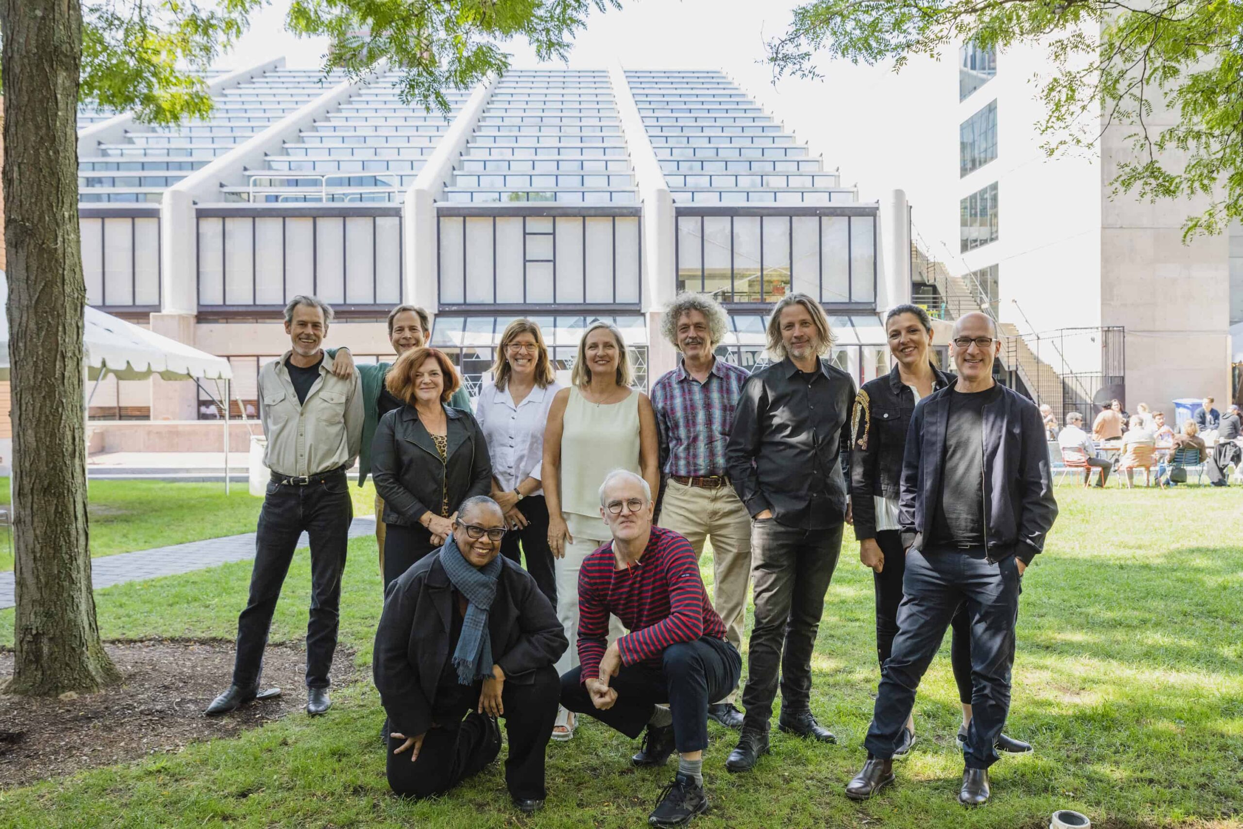 Graduates of the same cohort smile in the backyard of Gund Hall during the 2022 GSD Comeback