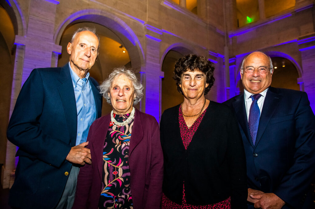 Four people gathered in formal clothes at event