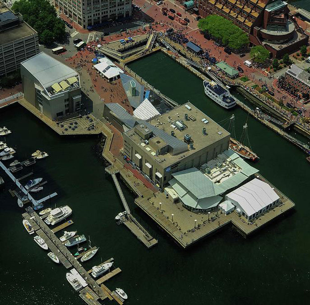 Aerial image of wharf with buildings jutting into water.