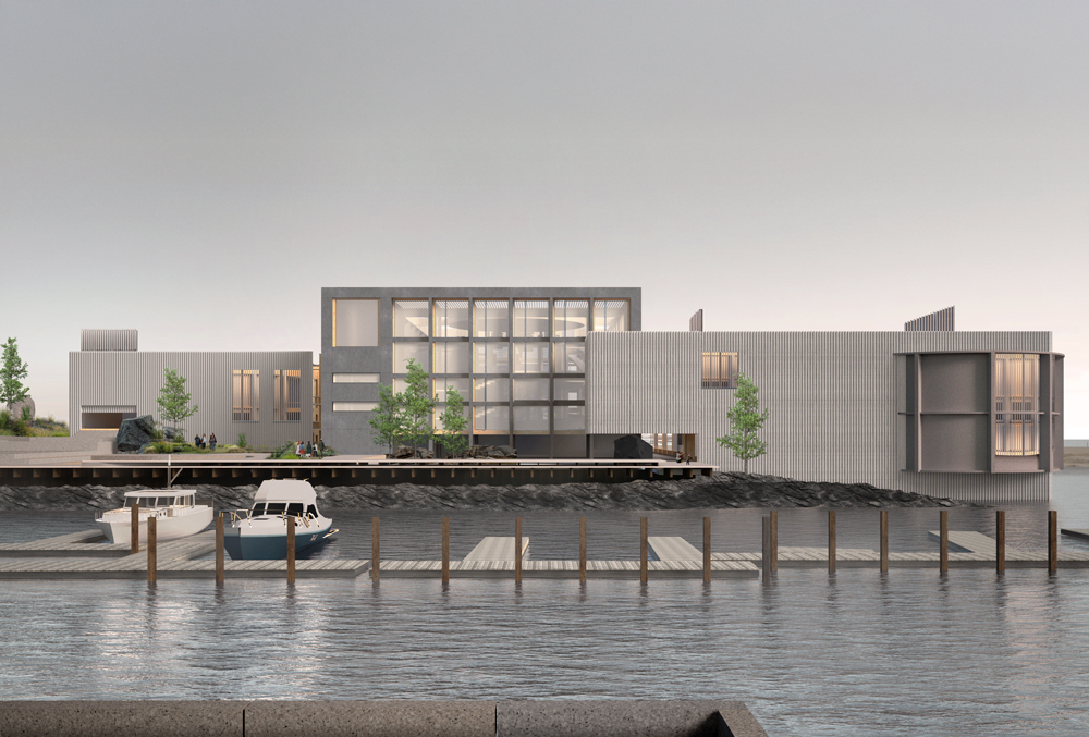 Three buildings adjoining overlooking a boat dock and the harbor.