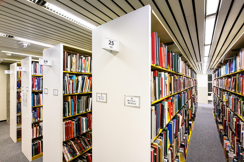 Rows of colorful books on shelves in a library.