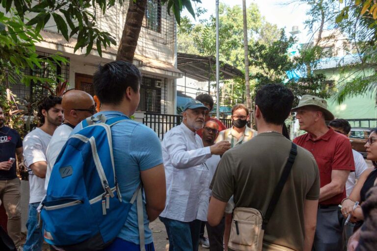 Two faculty members leading students through housing development. 