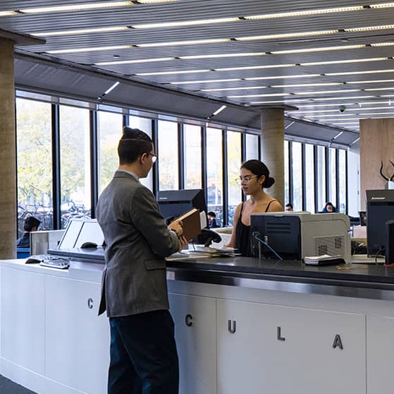 Students speaking at the circulation desk.