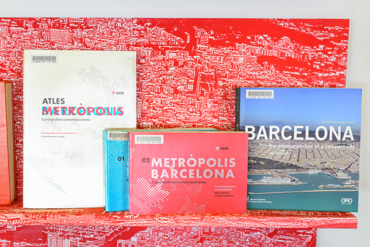 Red bookshelves displaying a variety of books.