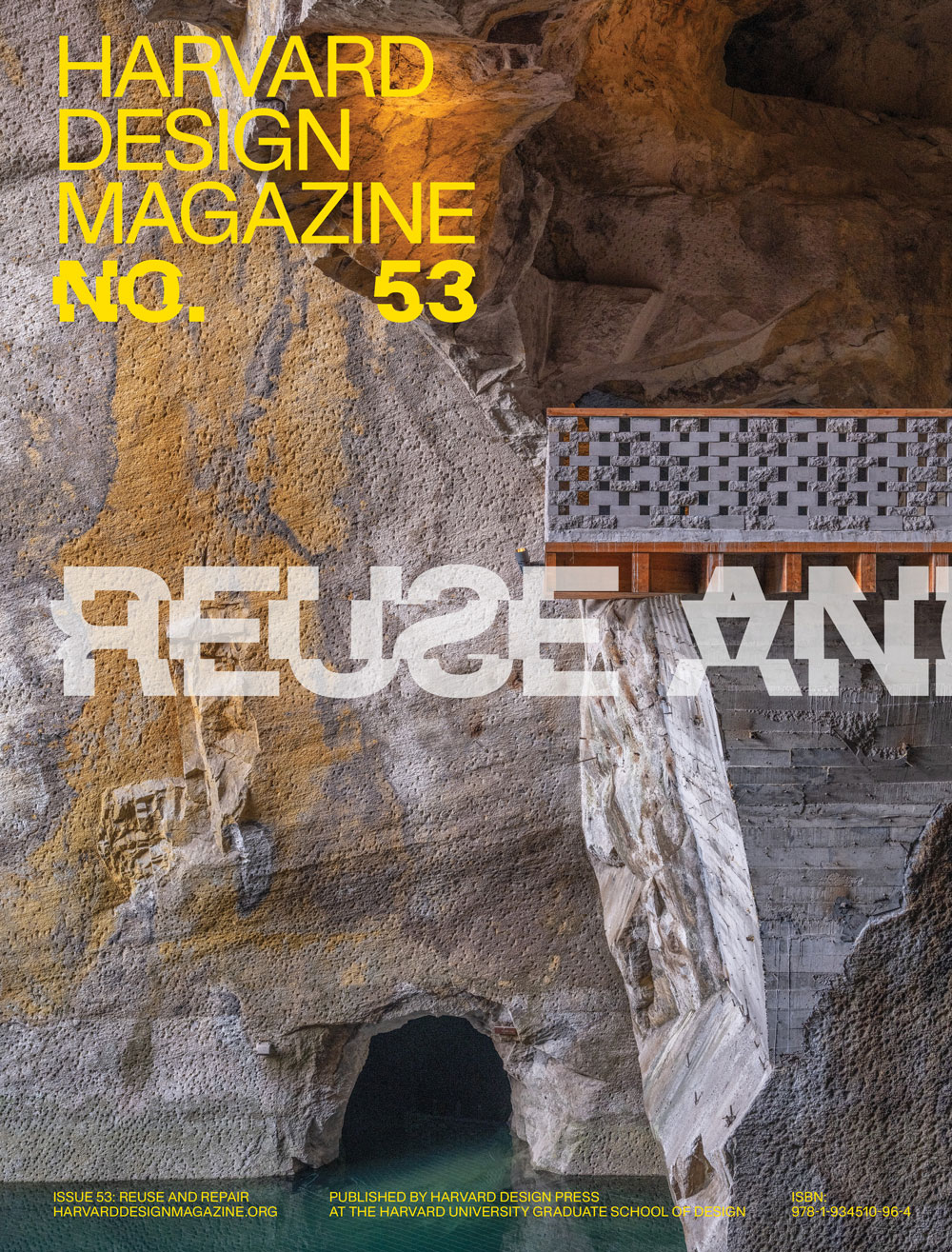 Cover of Harvard Design Magazine with a photograph of a stone wall from a quarry with streaks of orange and dark grey through a light grey surface. In the center is a brick fence where a walkway is constructed. Harvard Design Magazine appears in yellow type.