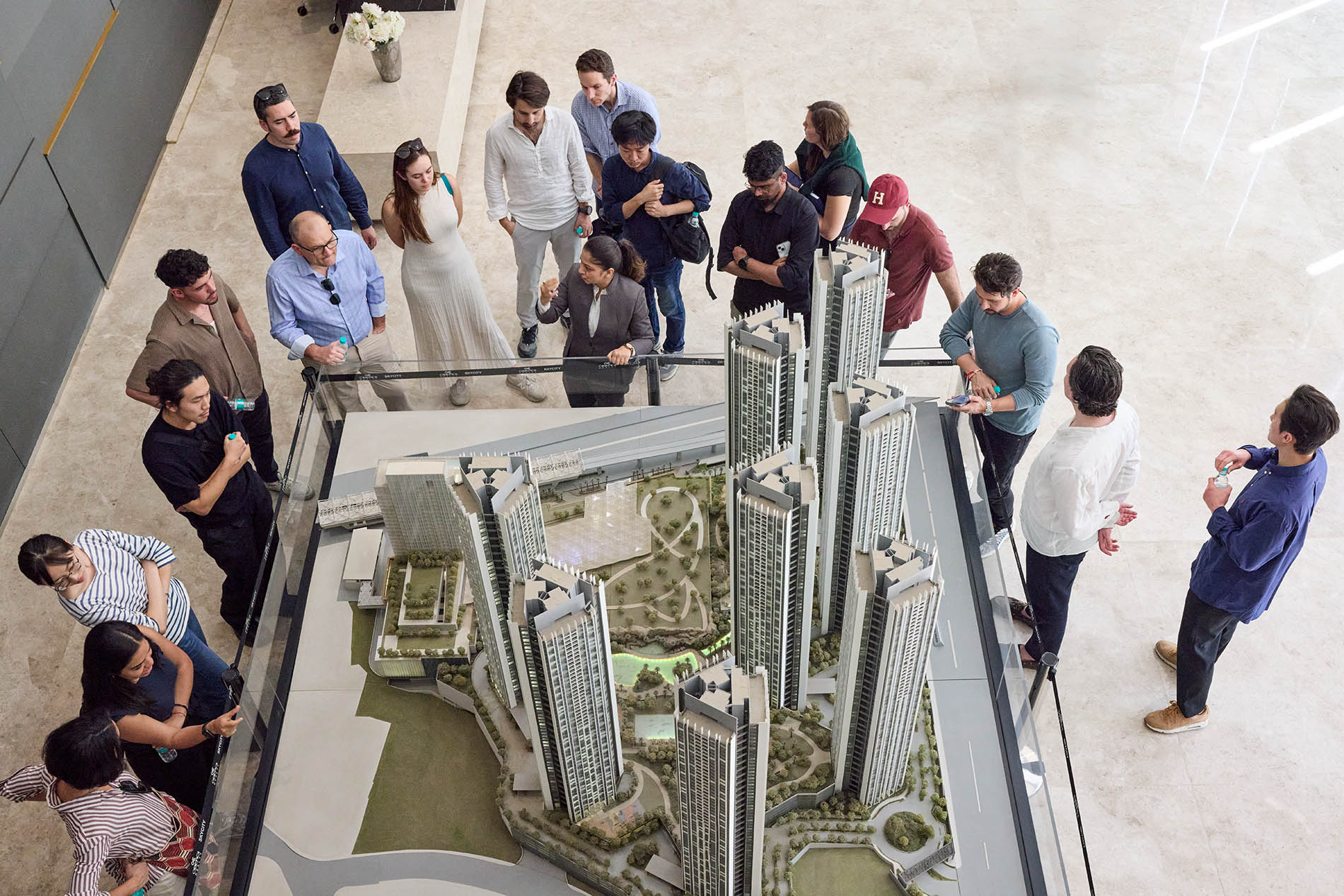 A group of students gathered around an architectural model of skyscrapers