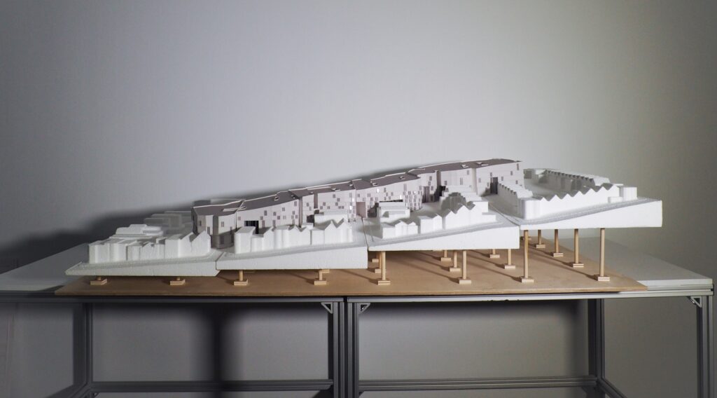 Architectural model of housing community crawling up several steps of elevation.