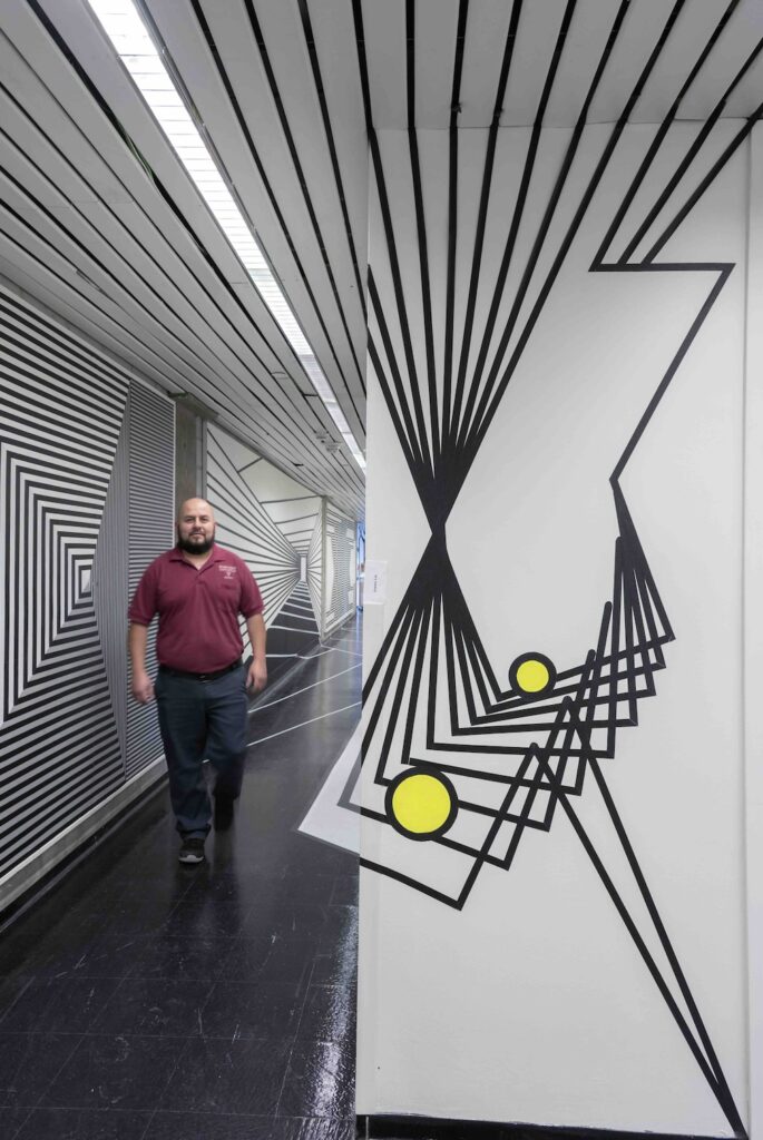 man in optical illusion hallway