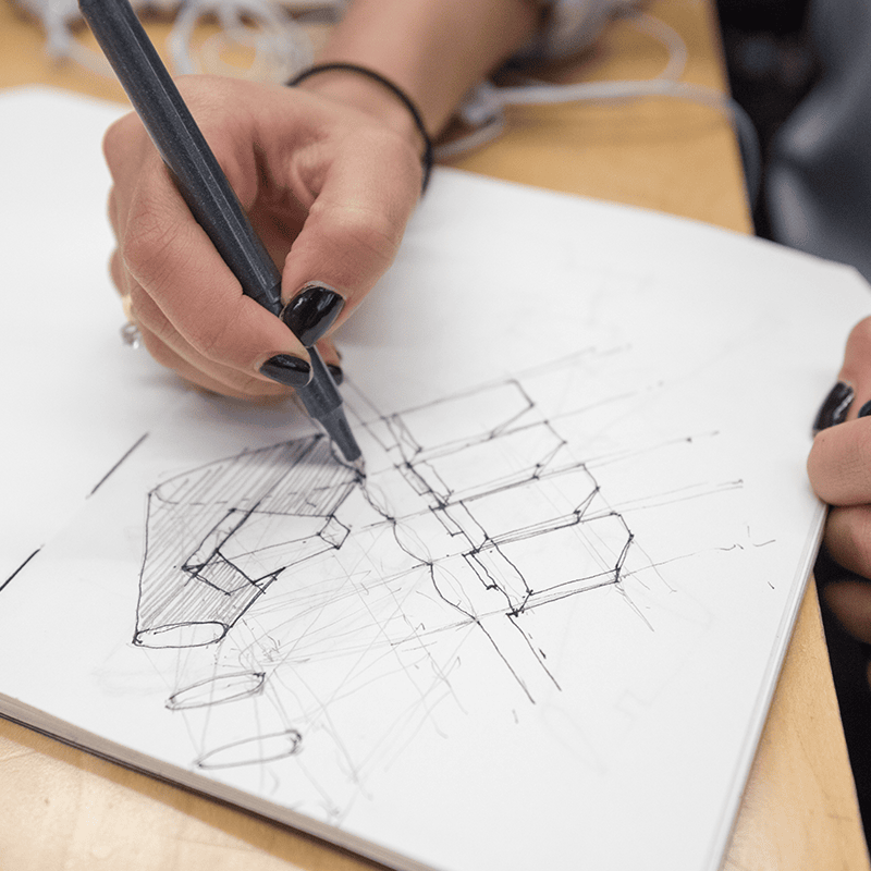 Hand drawing a diagram.