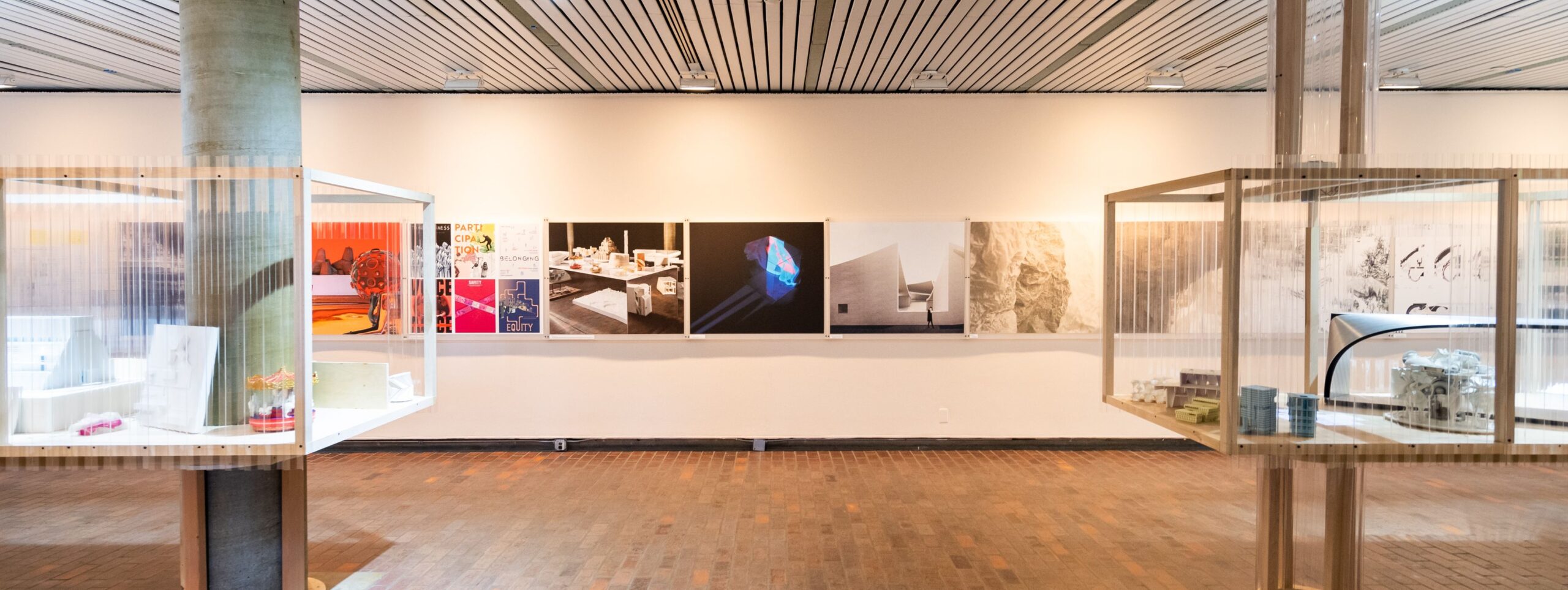 A gallery wall with models displayed in front.